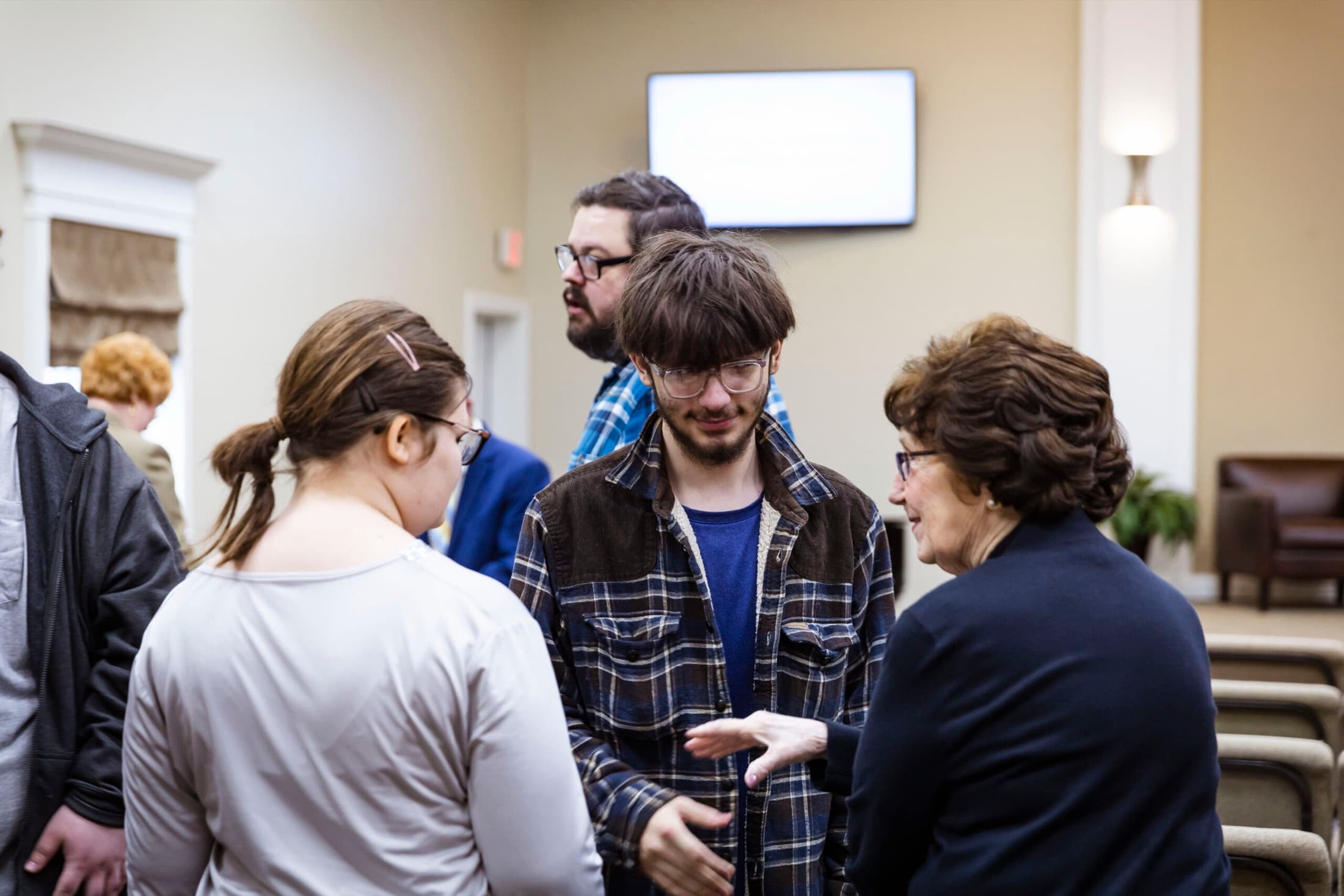 Members welcoming one another in the foyer at Calvary